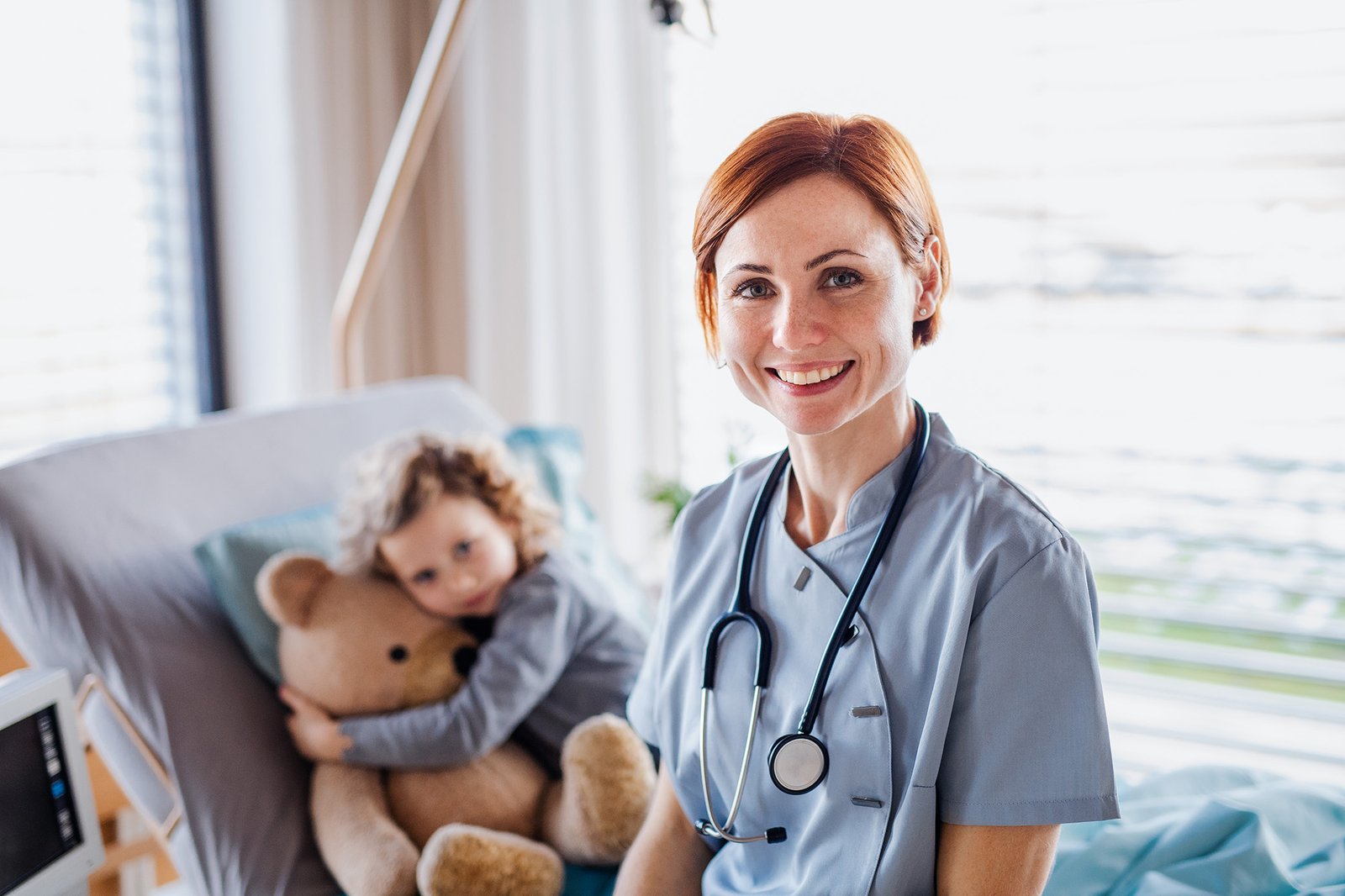 friendly-female-doctor-and-small-girl-in-bed-in-ho-5A5LE87-1.jpg